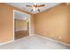 Unfurnished room featuring carpet and views to another room with tile floors at 6651 Sw 93Rd Ct, Ocala, FL 34481