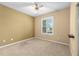 Bedroom with carpeted floors, ceiling fan and a large window at 6651 Sw 93Rd Ct, Ocala, FL 34481