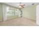 Sun-lit bedroom with neutral paint and a view into the bathroom at 6651 Sw 93Rd Ct, Ocala, FL 34481