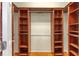 Walk-in closet with custom wooden shelving and hardwood floor at 6651 Sw 93Rd Ct, Ocala, FL 34481