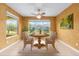 Bright dining room featuring a large table, neutral paint, and tile flooring at 6651 Sw 93Rd Ct, Ocala, FL 34481