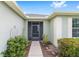 Close-up of the front entrance with screened porch and manicured landscaping at 6651 Sw 93Rd Ct, Ocala, FL 34481