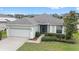 Charming single-story home with a well-manicured lawn and attached two-car garage at 6651 Sw 93Rd Ct, Ocala, FL 34481