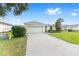 Lovely single-story home with driveway, green lawn, and a two-car garage at 6651 Sw 93Rd Ct, Ocala, FL 34481