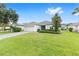 Beautiful single-story home with green lawn, palm trees and a two-car garage at 6651 Sw 93Rd Ct, Ocala, FL 34481