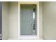 A green front door with sidelight and detailed trim at 6651 Sw 93Rd Ct, Ocala, FL 34481
