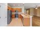 Kitchen featuring tile floor, stainless steel refrigerator, and adjacent living space at 6651 Sw 93Rd Ct, Ocala, FL 34481