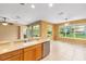 Bright kitchen with stainless steel appliances and breakfast bar overlooking living area at 6651 Sw 93Rd Ct, Ocala, FL 34481