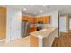 Kitchen featuring stainless steel appliances, tile flooring, and a raised breakfast bar at 6651 Sw 93Rd Ct, Ocala, FL 34481