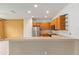 Open kitchen features stainless steel appliances and wooden cabinets at 6651 Sw 93Rd Ct, Ocala, FL 34481