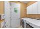 Bright laundry room featuring a washer, dryer, storage cabinets and doors at 6651 Sw 93Rd Ct, Ocala, FL 34481