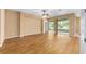 Bright living room featuring wood floors, ceiling fan, and sliding glass doors at 6651 Sw 93Rd Ct, Ocala, FL 34481