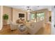 Staged living room featuring wood floors, contemporary furniture, and natural light at 6651 Sw 93Rd Ct, Ocala, FL 34481