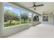 Covered patio with ceiling fans, neutral color scheme, and view of the grassy fenced-in backyard at 6651 Sw 93Rd Ct, Ocala, FL 34481