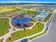 Aerial view showcases community's resort-style pool, splashpad, playground, and wide green spaces for outdoor enjoyment at 7641 Sw 63Rd Lane Road, Ocala, FL 34474