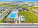 Aerial view featuring a pool, splashpad, playground, a sports court, and green spaces for community enjoyment at 7641 Sw 63Rd Lane Road, Ocala, FL 34474