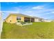 Expansive backyard featuring raised garden beds, a manicured lawn, and a screened lanai at 7641 Sw 63Rd Lane Road, Ocala, FL 34474