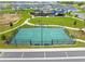 Aerial view of the community basketball court adjacent to parking with neighborhood amenities nearby at 7641 Sw 63Rd Lane Road, Ocala, FL 34474