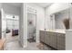 Bright bathroom with granite counters, gray cabinets, and an adjacent bedroom at 7641 Sw 63Rd Lane Road, Ocala, FL 34474