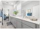 Bathroom with a quartz countertop, neutral cabinets, and a well-lit vanity at 7641 Sw 63Rd Lane Road, Ocala, FL 34474