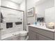 Bathroom featuring neutral cabinets, quartz countertop, and glass enclosed shower at 7641 Sw 63Rd Lane Road, Ocala, FL 34474