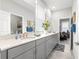 Bathroom with dual sinks, quartz countertop, and ample storage at 7641 Sw 63Rd Lane Road, Ocala, FL 34474