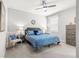 Cozy bedroom with a ceiling fan, gray headboard, and coordinated decor at 7641 Sw 63Rd Lane Road, Ocala, FL 34474