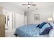 Bright bedroom featuring a ceiling fan, closet, and stylish blue patterned bedding at 7641 Sw 63Rd Lane Road, Ocala, FL 34474