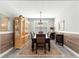Charming dining room featuring wood-look accent wall and view of backyard at 7641 Sw 63Rd Lane Road, Ocala, FL 34474