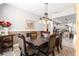 Elegant dining room with chandelier, decorative rug, and view into the modern kitchen at 7641 Sw 63Rd Lane Road, Ocala, FL 34474