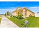 Bright yellow home featuring an inviting front porch, pristine landscaping, and an American flag waving proudly at 7641 Sw 63Rd Lane Road, Ocala, FL 34474