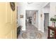 Welcoming foyer with neutral tones, decorative rug, and a glimpse into the home's open layout at 7641 Sw 63Rd Lane Road, Ocala, FL 34474