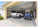 Spacious garage with ample storage, a truck, and a golf cart at 7641 Sw 63Rd Lane Road, Ocala, FL 34474