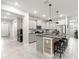 Bright kitchen boasts stainless appliances, granite counters and a large island with seating at 7641 Sw 63Rd Lane Road, Ocala, FL 34474