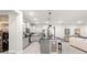 Open kitchen with stainless appliances, granite counters, kitchen island, and seamless flow to living area at 7641 Sw 63Rd Lane Road, Ocala, FL 34474