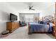 Inviting main bedroom featuring a ceiling fan, soft carpet, and cozy seating area at 7641 Sw 63Rd Lane Road, Ocala, FL 34474