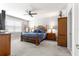 Comfortable main bedroom featuring a ceiling fan, soft carpet, and ample space at 7641 Sw 63Rd Lane Road, Ocala, FL 34474