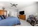 Cozy main bedroom with a ceiling fan, dresser, and a sitting chair at 7641 Sw 63Rd Lane Road, Ocala, FL 34474