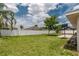 The large backyard features lush grass, a playground, a basketball hoop and a covered patio area at 8170 Sw 56Th Avenue Rd, Ocala, FL 34476