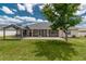 A spacious backyard with a well-maintained lawn, gazebo and a covered patio, perfect for outdoor relaxation at 8170 Sw 56Th Avenue Rd, Ocala, FL 34476