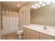 Bathroom features a vanity, a toilet, and shower and tub with a shower curtain at 8170 Sw 56Th Avenue Rd, Ocala, FL 34476
