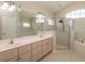 Bright bathroom with double sinks, walk-in shower, bathtub and tile floor at 8170 Sw 56Th Avenue Rd, Ocala, FL 34476