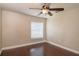 This bedroom features hardwood floors, a ceiling fan, and a window to bring in natural light at 8170 Sw 56Th Avenue Rd, Ocala, FL 34476