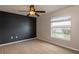 Bedroom featuring a single window, a dark accent wall and neutral carpet at 8170 Sw 56Th Avenue Rd, Ocala, FL 34476