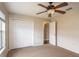 Bedroom featuring neutral carpet, a ceiling fan and a closet with white doors at 8170 Sw 56Th Avenue Rd, Ocala, FL 34476
