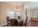 Dining room view with dark wood table set and elegant chandelier at 8170 Sw 56Th Avenue Rd, Ocala, FL 34476