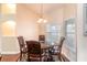 Formal dining room with dark wood table set and elegant lighting fixture at 8170 Sw 56Th Avenue Rd, Ocala, FL 34476