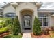 Elegant entrance featuring double doors framed by lush landscaping at 8170 Sw 56Th Avenue Rd, Ocala, FL 34476