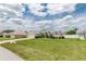 Well-maintained home featuring a lush lawn, mature landscaping, and a two-car garage at 8170 Sw 56Th Avenue Rd, Ocala, FL 34476