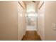 Hallway leading to bathroom featuring tile floors and linen closets at 8170 Sw 56Th Avenue Rd, Ocala, FL 34476